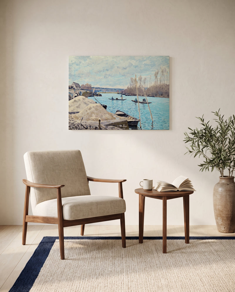The Seine at Port-Marly by Alfred Sisley as a stretched canvas above a linen lounge chair in a reading corner