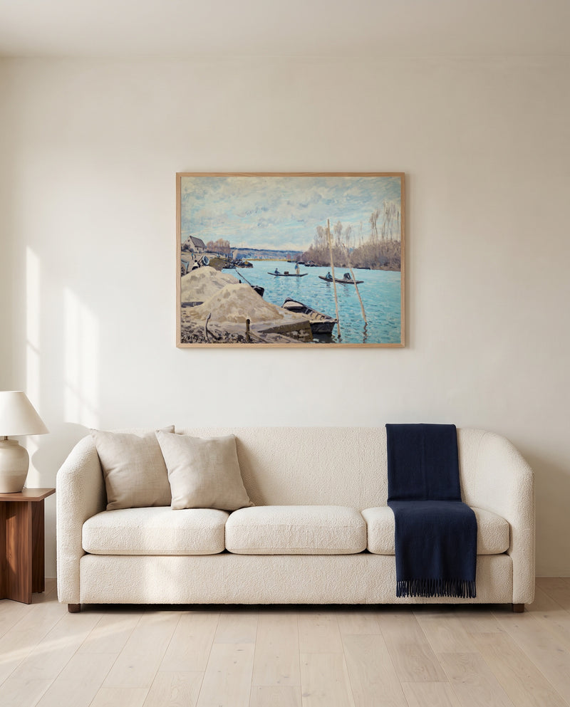 The Seine at Port-Marly by Alfred Sisley framed in natural oak above a cream sofa in a warm living room