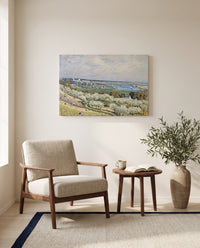 Terrace at Saint-Germain by Alfred Sisley as a stretched canvas above a linen lounge chair in a reading corner