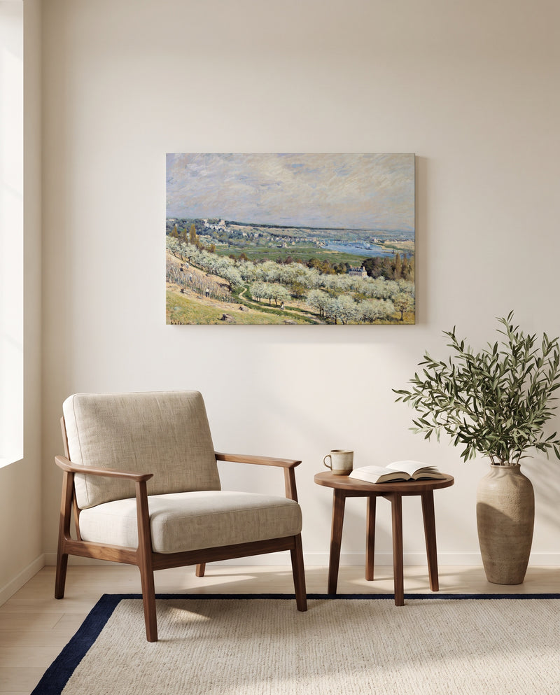 Terrace at Saint-Germain by Alfred Sisley as a stretched canvas above a linen lounge chair in a reading corner