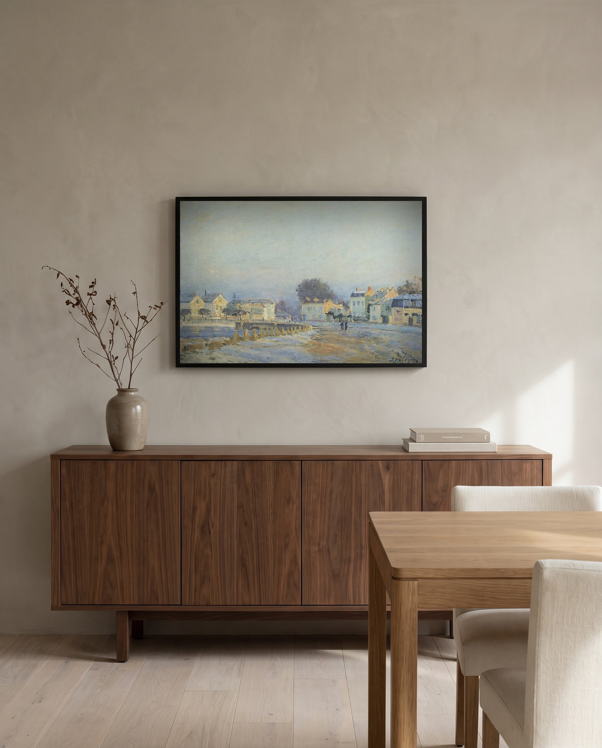 Watering Pond at Marly by Alfred Sisley in a black frame above a walnut sideboard in a dining room
