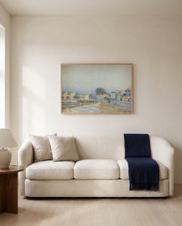 Watering Pond at Marly by Alfred Sisley framed in natural oak above a cream sofa in a warm living room