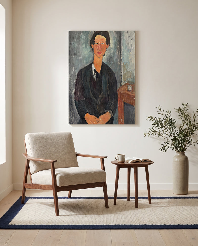 Chaïm Soutine by Amedeo Modigliani as a stretched canvas above a linen lounge chair in a reading corner