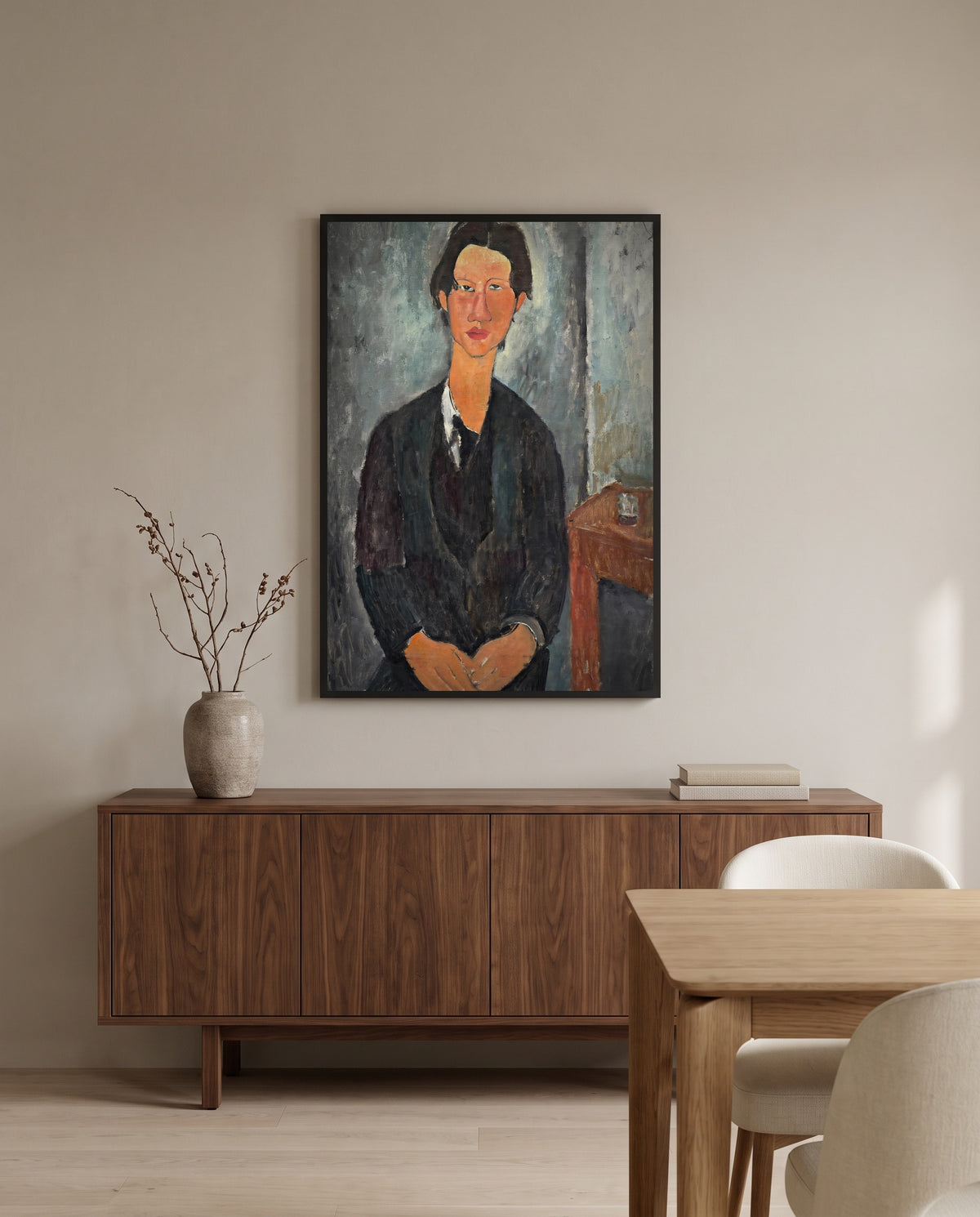 Chaïm Soutine by Amedeo Modigliani in a black frame above a walnut sideboard in a dining room