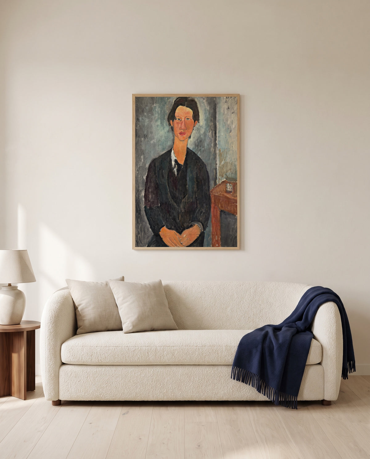 Chaïm Soutine by Amedeo Modigliani framed in natural oak above a cream sofa in a warm living room