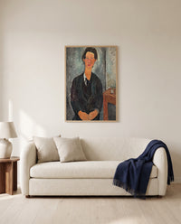 Chaïm Soutine by Amedeo Modigliani framed in natural oak above a cream sofa in a warm living room