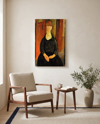 Flower Vendor by Amedeo Modigliani as a stretched canvas above a linen lounge chair in a reading corner