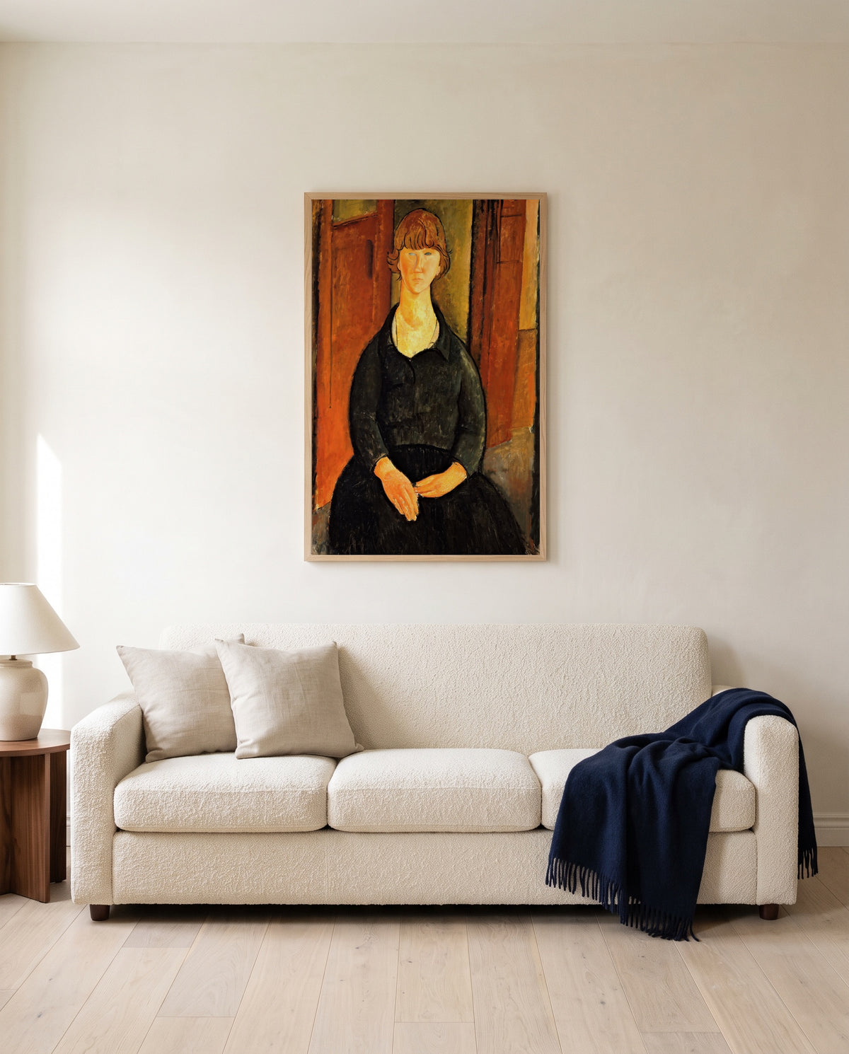 Flower Vendor by Amedeo Modigliani framed in natural oak above a cream sofa in a warm living room