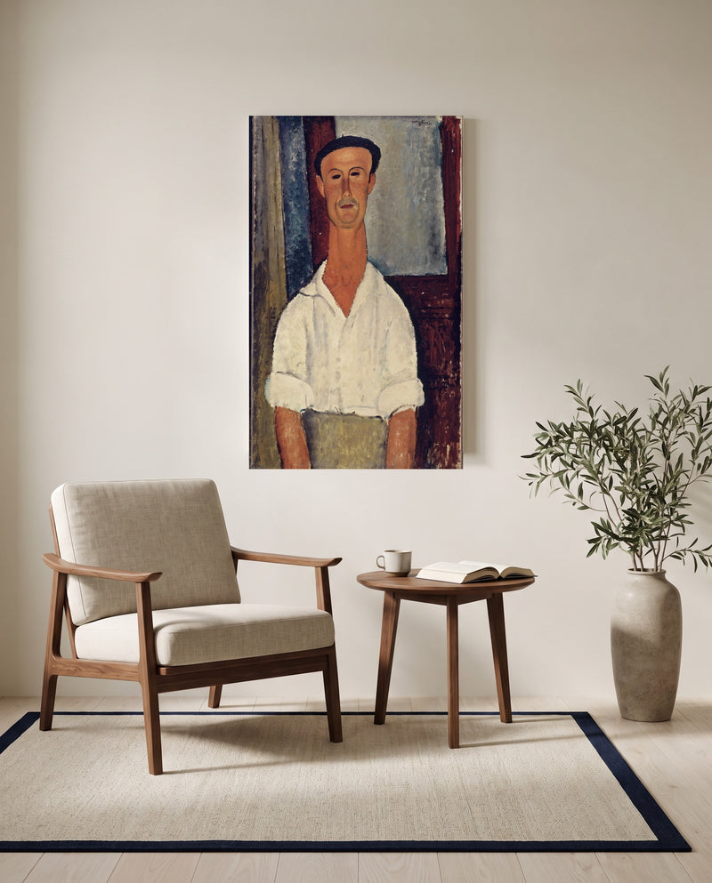 Gaston Modot by Amedeo Modigliani as a stretched canvas above a linen lounge chair in a reading corner
