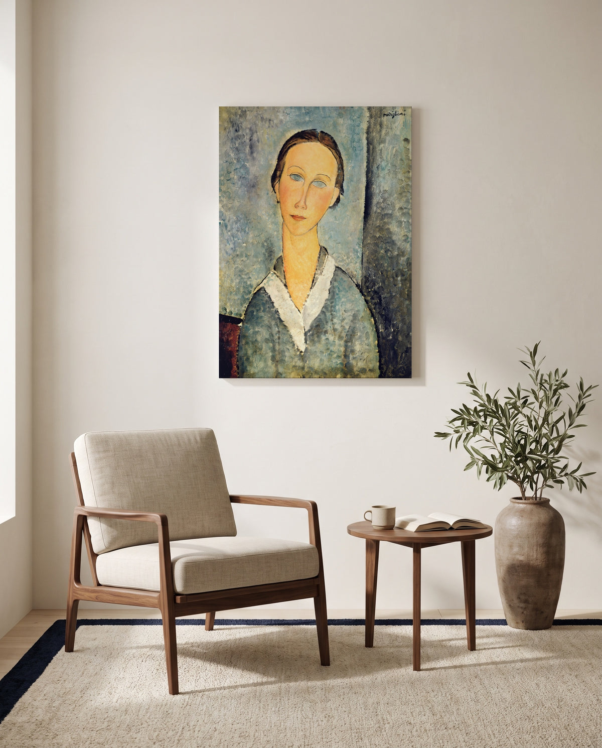 Girl in a Sailor’s Blouse by Amedeo Modigliani as a stretched canvas above a linen lounge chair in a reading corner