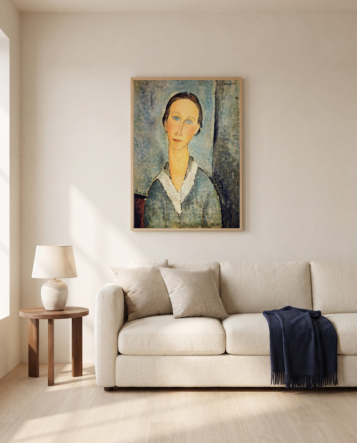 Girl in a Sailor’s Blouse by Amedeo Modigliani framed in natural oak above a cream sofa in a warm living room