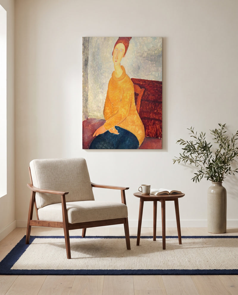 Jeanne in Yellow Sweater by Amedeo Modigliani as a stretched canvas above a linen lounge chair in a reading corner