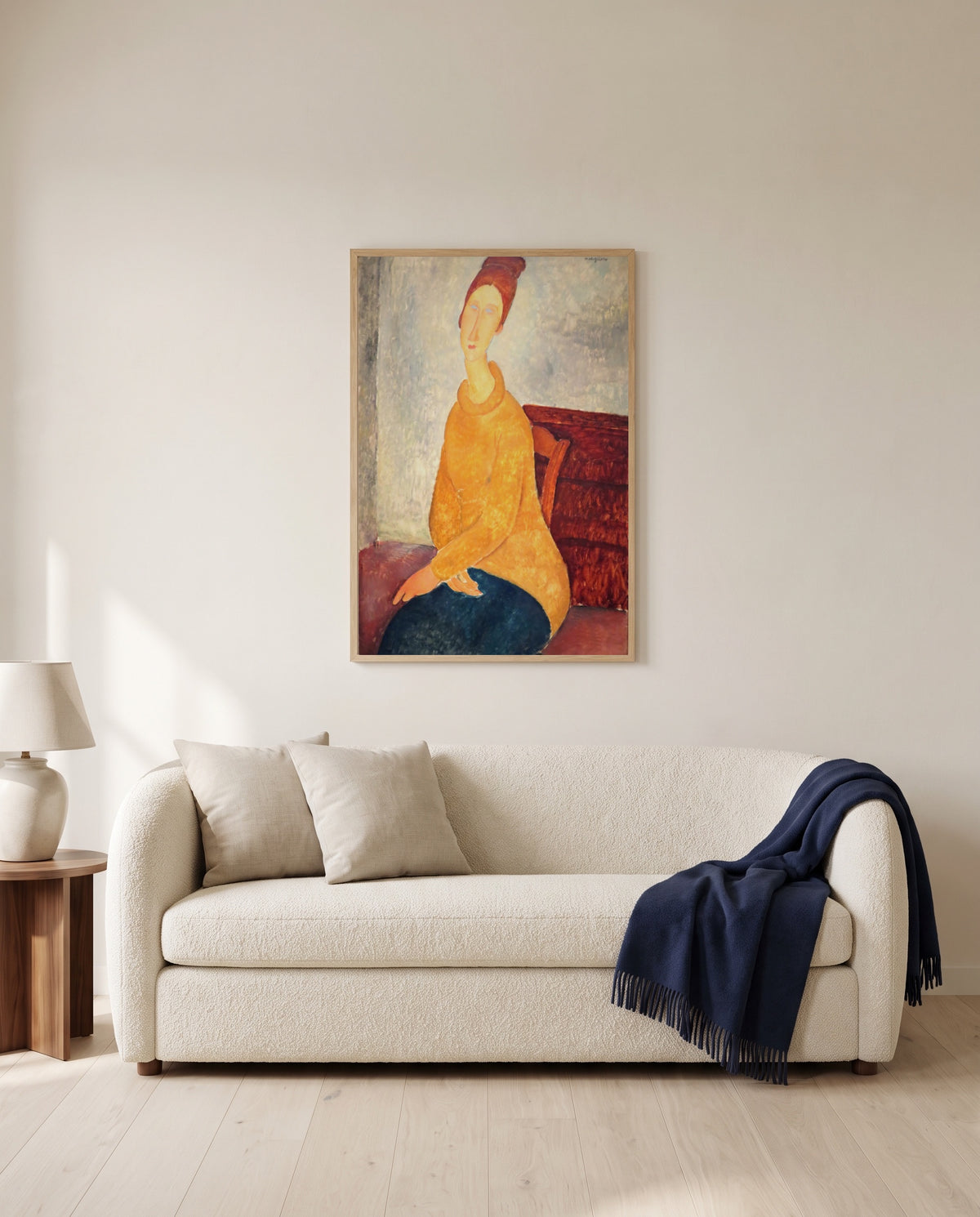 Jeanne in Yellow Sweater by Amedeo Modigliani framed in natural oak above a cream sofa in a warm living room