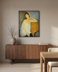 Jeanne Hébuterne (1919) by Amedeo Modigliani in a black frame above a walnut sideboard in a dining room