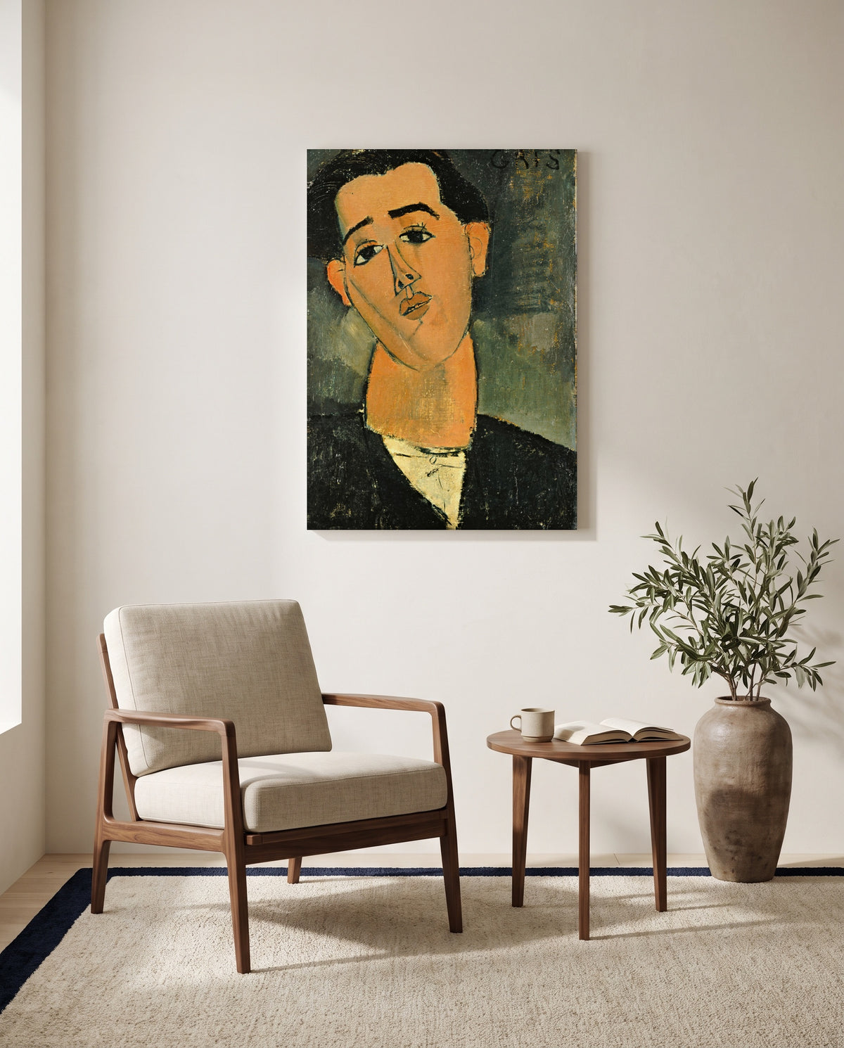 Juan Gris by Amedeo Modigliani as a stretched canvas above a linen lounge chair in a reading corner
