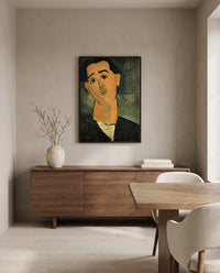 Juan Gris by Amedeo Modigliani in a black frame above a walnut sideboard in a dining room