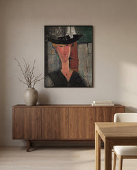 Madam Pompadour by Amedeo Modigliani in a black frame above a walnut sideboard in a dining room