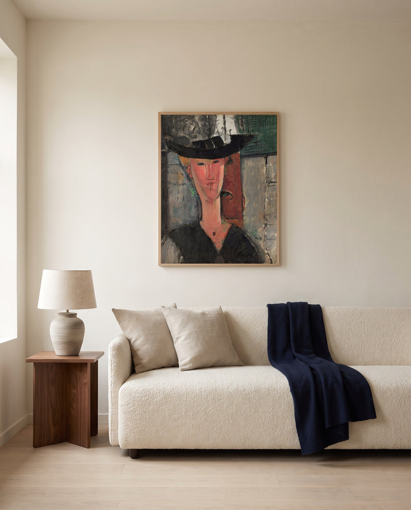 Madam Pompadour by Amedeo Modigliani framed in natural oak above a cream sofa in a warm living room
