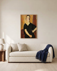 Madame Amédée by Amedeo Modigliani framed in natural oak above a cream sofa in a warm living room