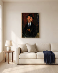 Paul Guillaume, Novo Pilota by Amedeo Modigliani framed in natural oak above a cream sofa in a warm living room
