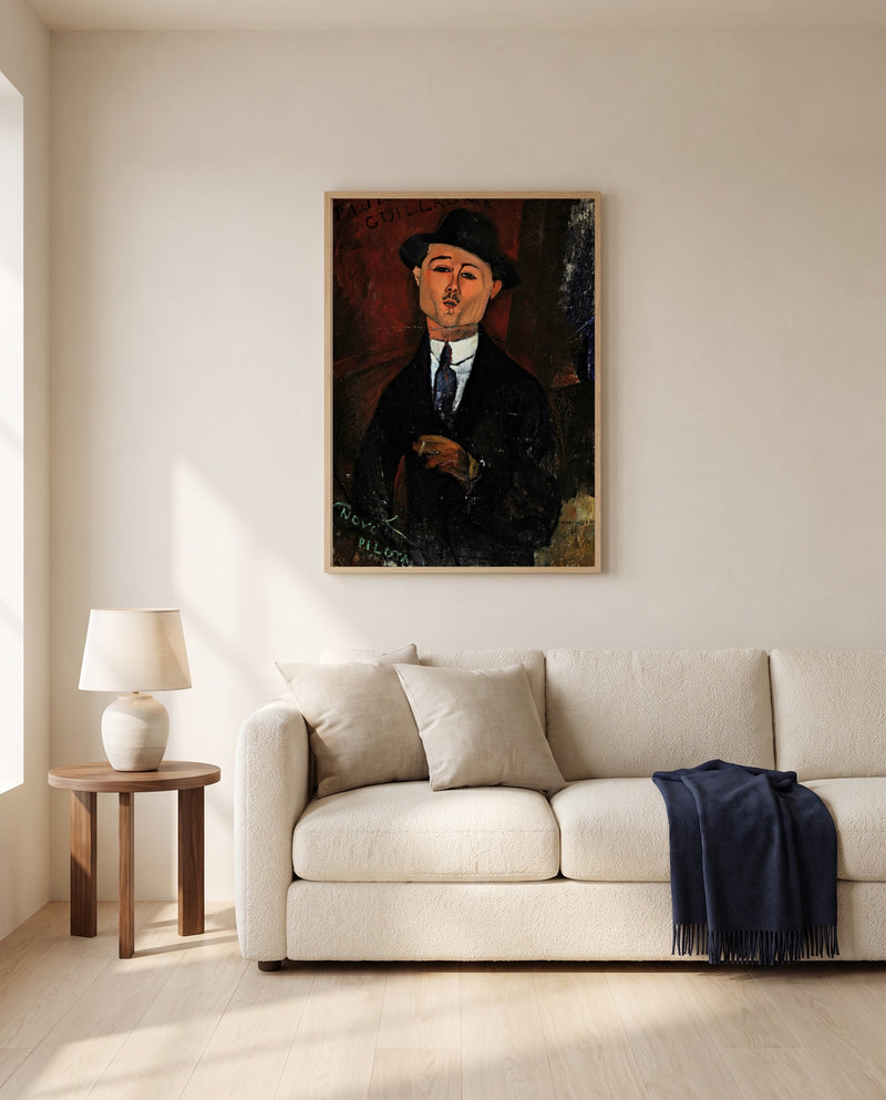Paul Guillaume, Novo Pilota by Amedeo Modigliani framed in natural oak above a cream sofa in a warm living room