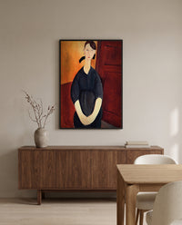 Paulette Jourdain by Amedeo Modigliani in a black frame above a walnut sideboard in a dining room
