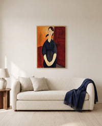 Paulette Jourdain by Amedeo Modigliani framed in natural oak above a cream sofa in a warm living room