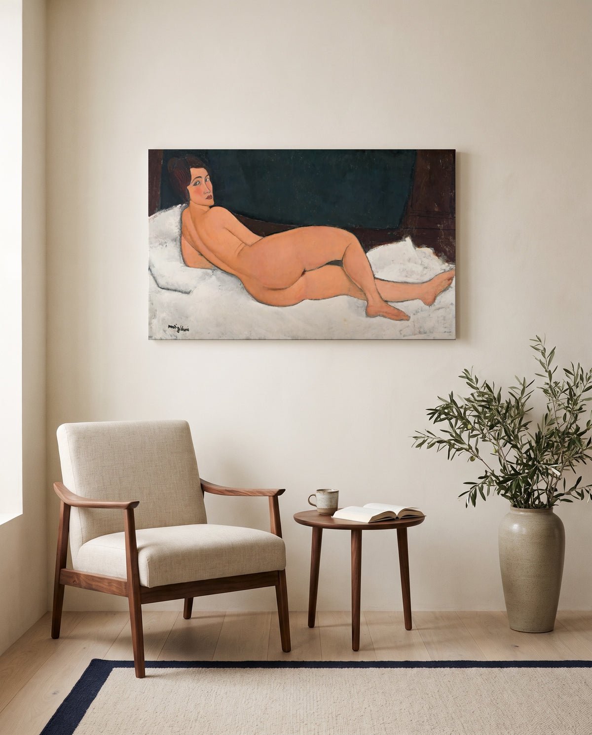 Reclining Nude (Left Side) by Amedeo Modigliani as a stretched canvas above a linen lounge chair in a reading corner