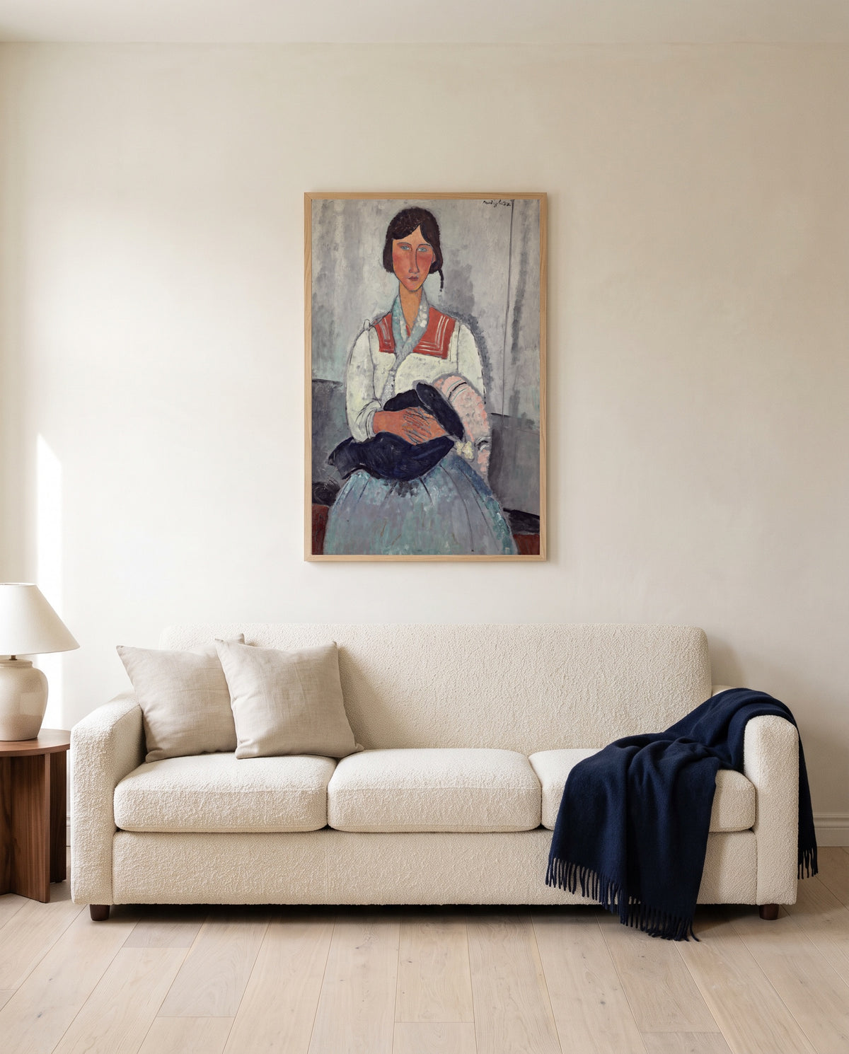 Roma Woman with Baby by Amedeo Modigliani framed in natural oak above a cream sofa in a warm living room