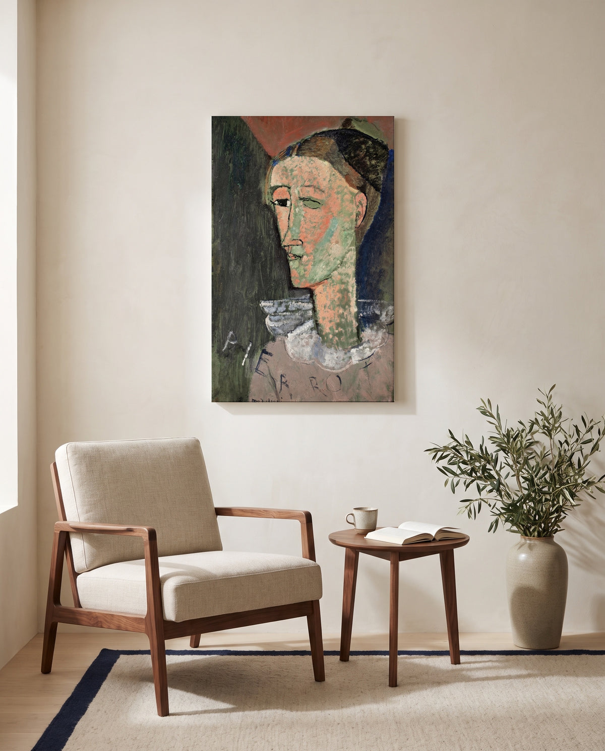 Self-Portrait as Pierrot by Amedeo Modigliani as a stretched canvas above a linen lounge chair in a reading corner