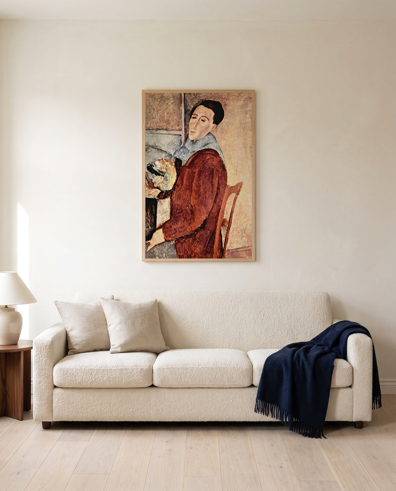 Self-Portrait by Amedeo Modigliani framed in natural oak above a cream sofa in a warm living room