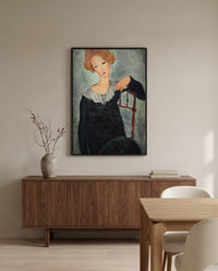 Woman with Red Hair by Amedeo Modigliani in a black frame above a walnut sideboard in a dining room