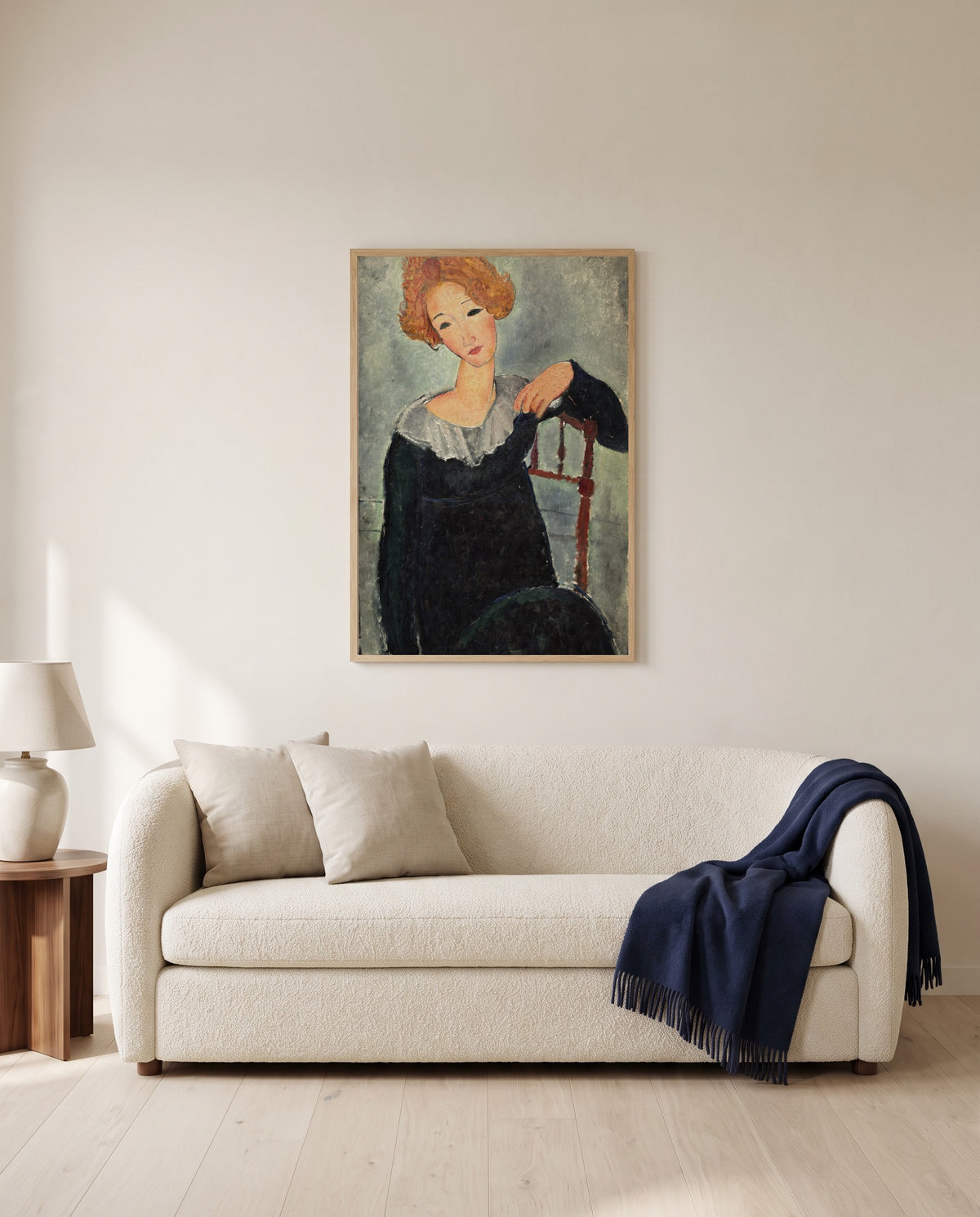 Woman with Red Hair by Amedeo Modigliani framed in natural oak above a cream sofa in a warm living room