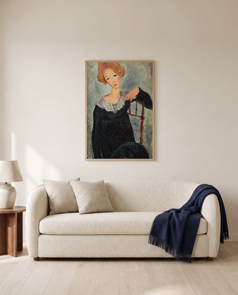 Woman with Red Hair by Amedeo Modigliani framed in natural oak above a cream sofa in a warm living room