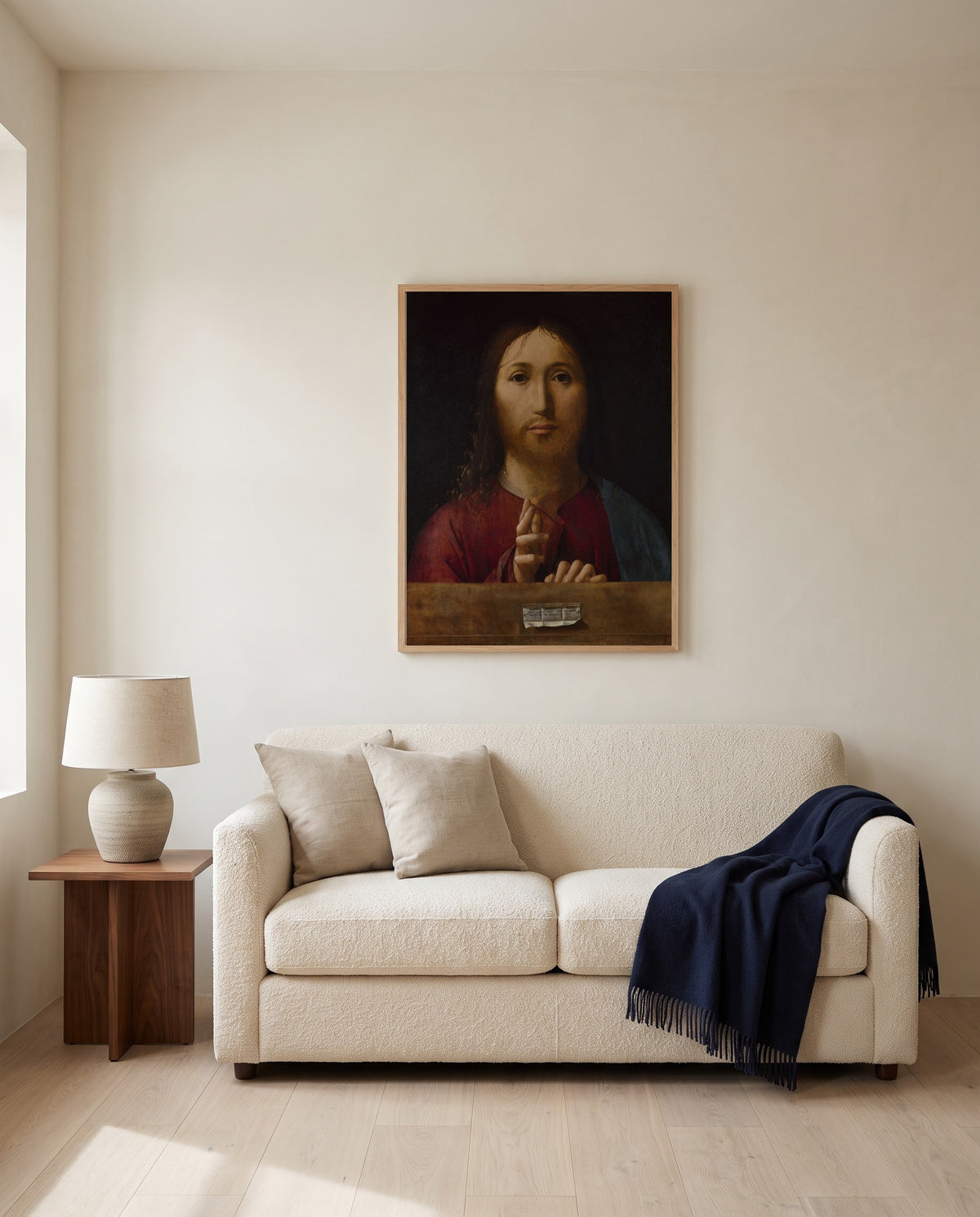 Christ Blessing by Antonello da Messina framed in natural oak above a cream sofa in a warm living room