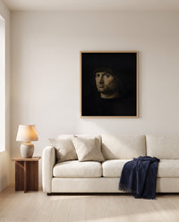 Il Condottiere by Antonello da Messina framed in natural oak above a cream sofa in a warm living room