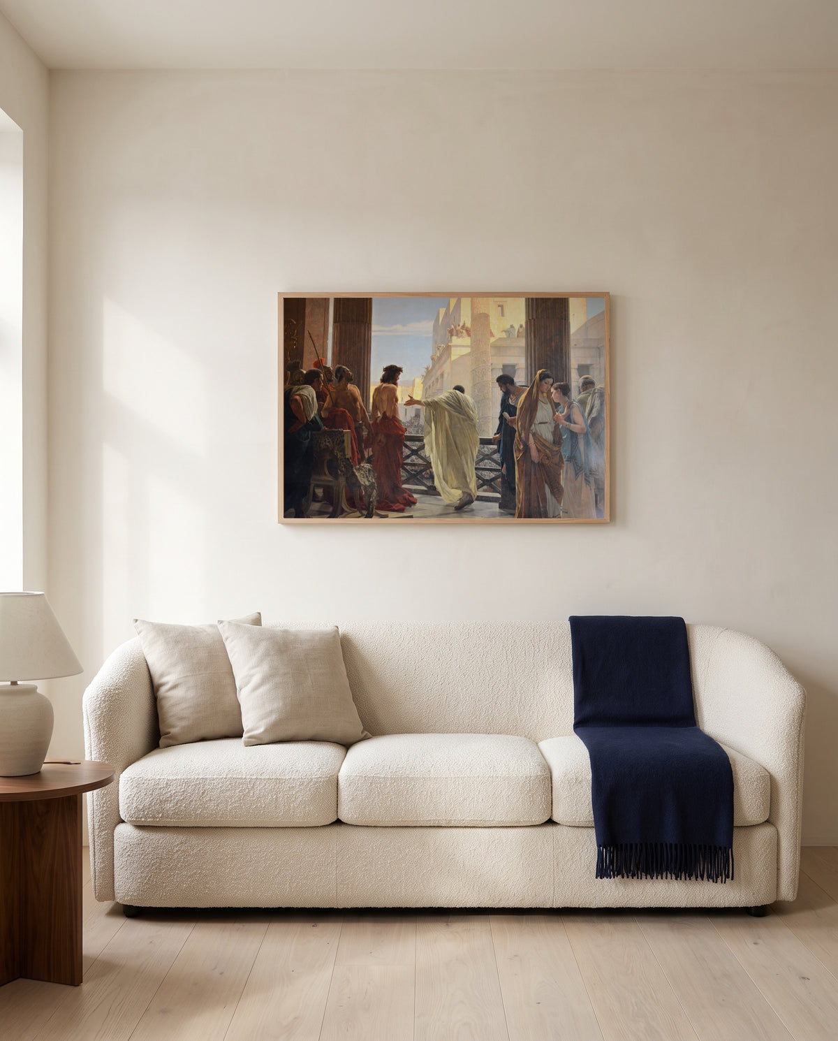 Ecce Homo by Antonio Ciseri framed in natural oak above a cream sofa in a warm living room
