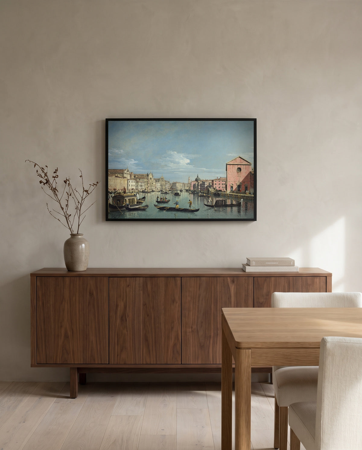 Grand Canal, Santa Croce by Bernardo Bellotto in a black frame above a walnut sideboard in a dining room