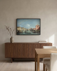 Grand Canal, Santa Croce by Bernardo Bellotto in a black frame above a walnut sideboard in a dining room