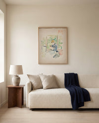 Sewing near the Window by Berthe Morisot framed in natural oak above a cream sofa in a warm living room