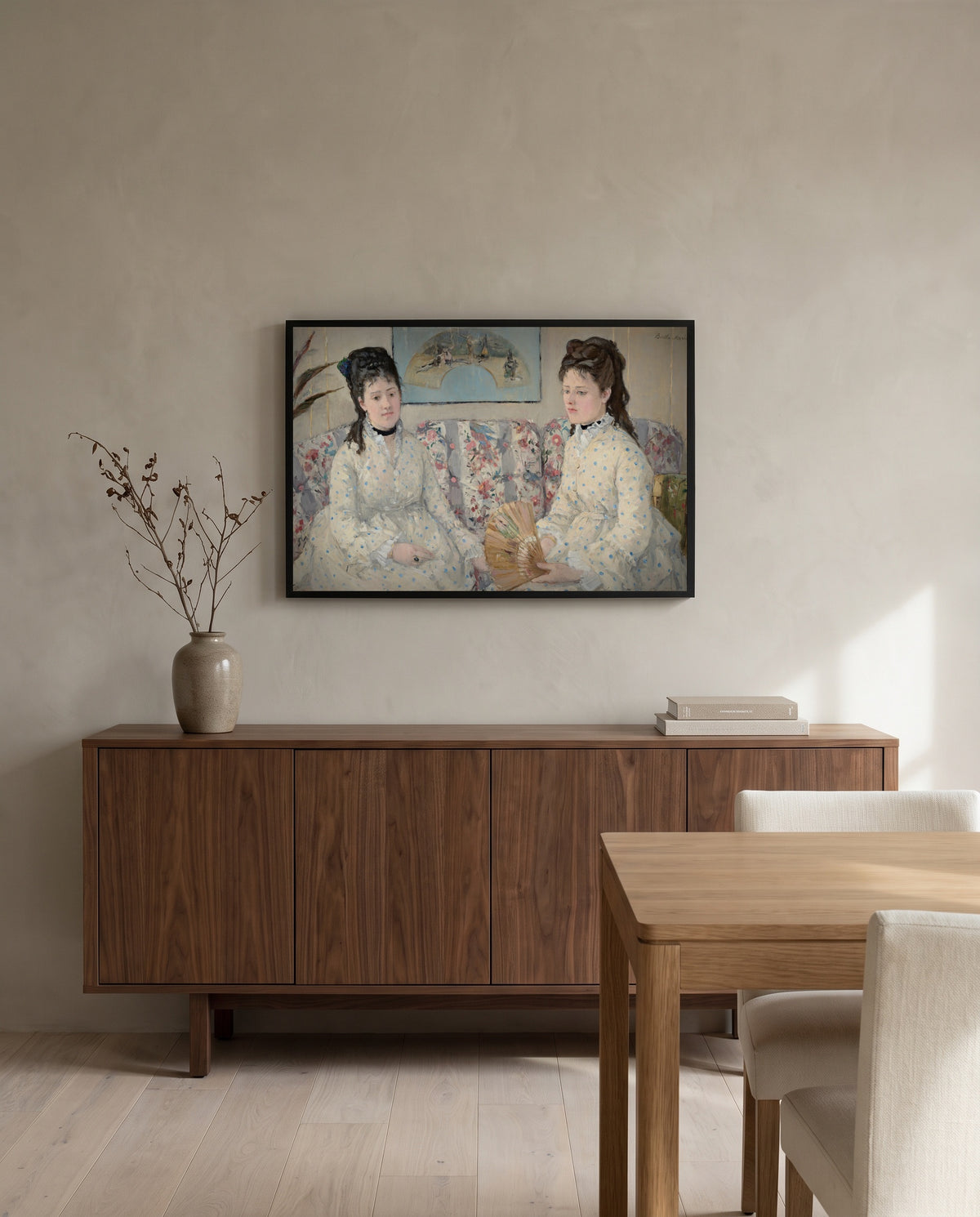 The Sisters by Berthe Morisot in a black frame above a walnut sideboard in a dining room