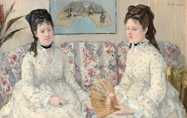 The Sisters by Berthe Morisot: two young women in white dresses with blue dots on a flowered sofa, one holding a fan
