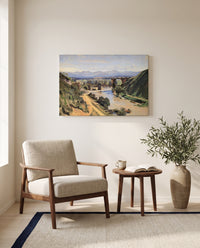 The Bridge at Narni by Camille Corot as a stretched canvas above a linen lounge chair in a reading corner