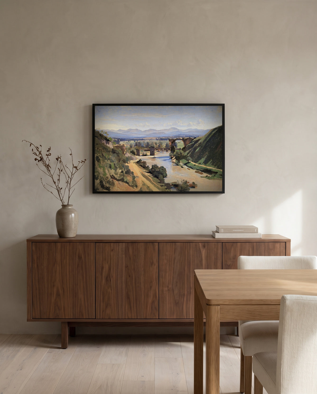 The Bridge at Narni by Camille Corot in a black frame above a walnut sideboard in a dining room