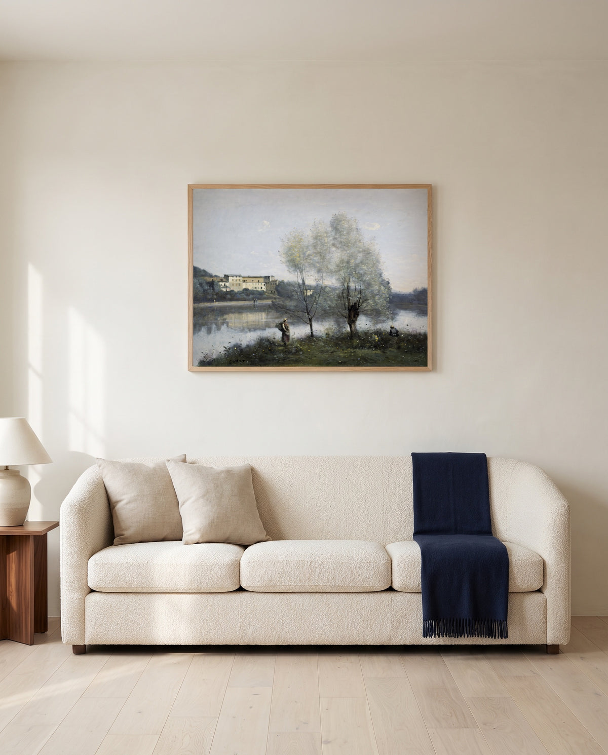 Ville-d’Avray by Camille Corot framed in natural oak above a cream sofa in a warm living room