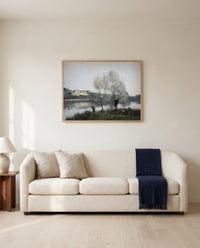Ville-d’Avray by Camille Corot framed in natural oak above a cream sofa in a warm living room