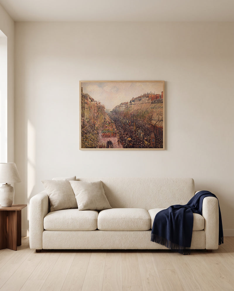 Boulevard Montmartre, Mardi Gras by Camille Pissarro framed in natural oak above a cream sofa in a warm living room