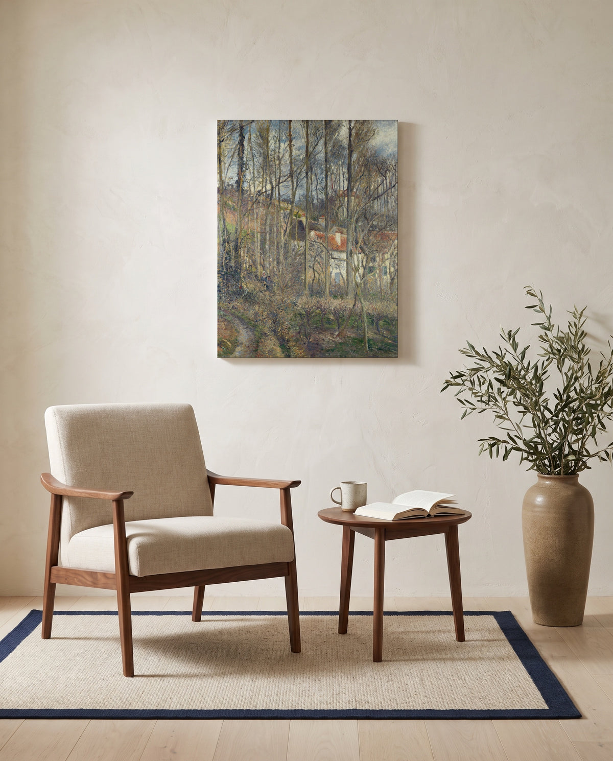 The Côte des Bœufs by Camille Pissarro as a stretched canvas above a linen lounge chair in a reading corner