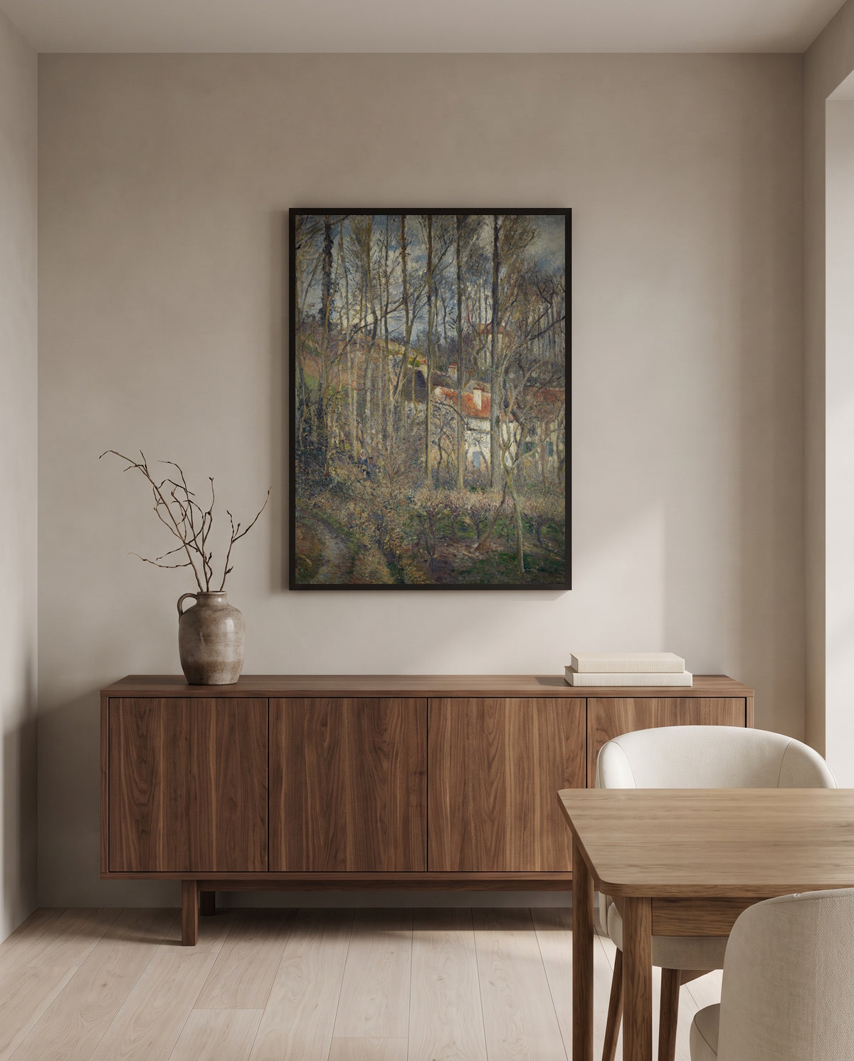 The Côte des Bœufs by Camille Pissarro in a black frame above a walnut sideboard in a dining room