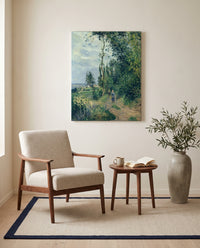 Côte des Grouettes by Camille Pissarro as a stretched canvas above a linen lounge chair in a reading corner
